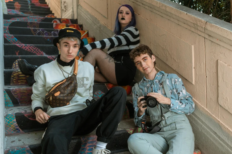 the three friends are posing on some stairs