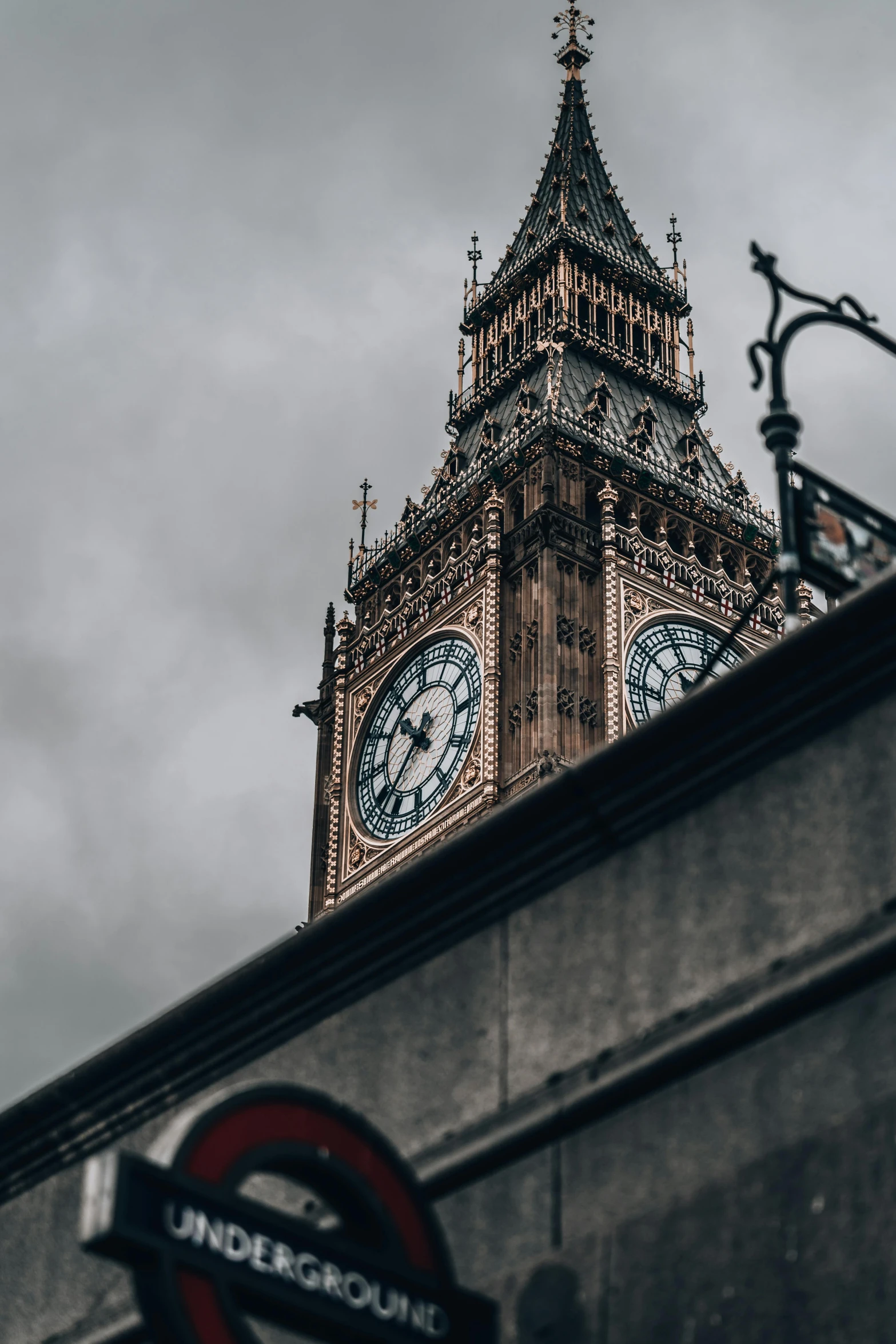 a large clock tower that is behind a building