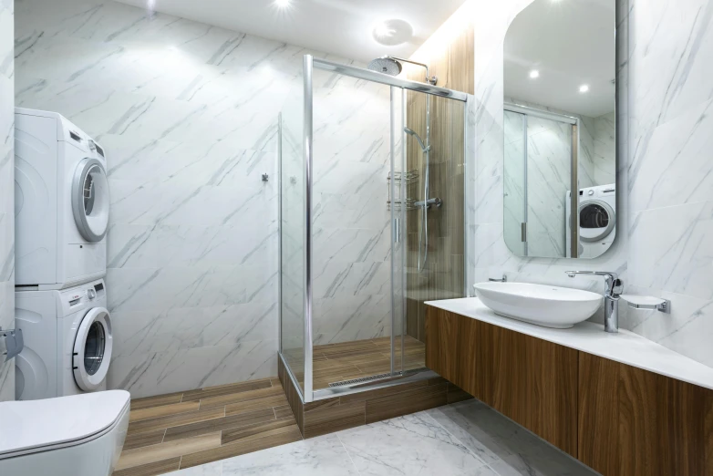 a large bathroom with toilet, mirror, wash basin and dryer