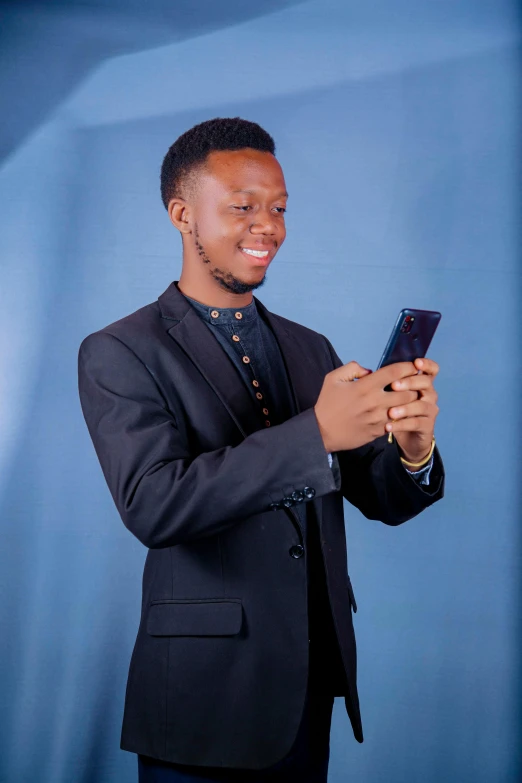 a black man is checking his cellphone while smiling