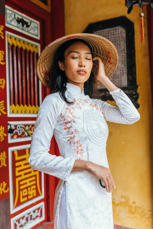 a woman is wearing a hat with flowers on it