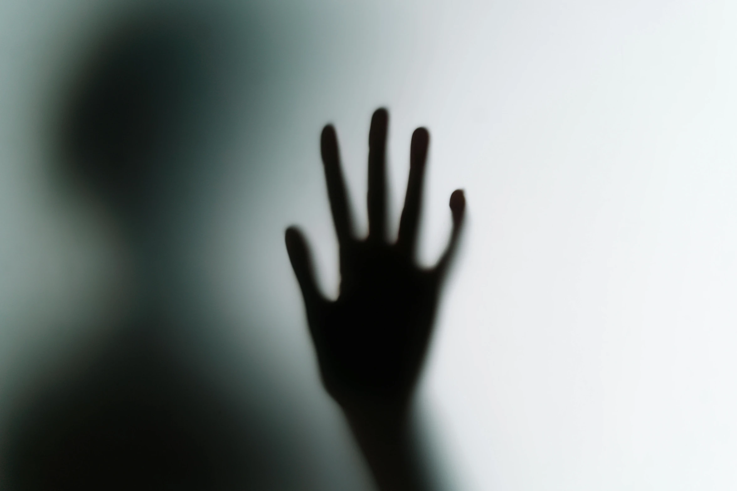 a person is shadowd in the air with their hand