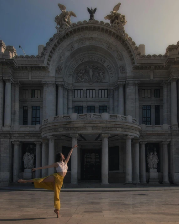 a person jumping in the air while standing in front of a large building