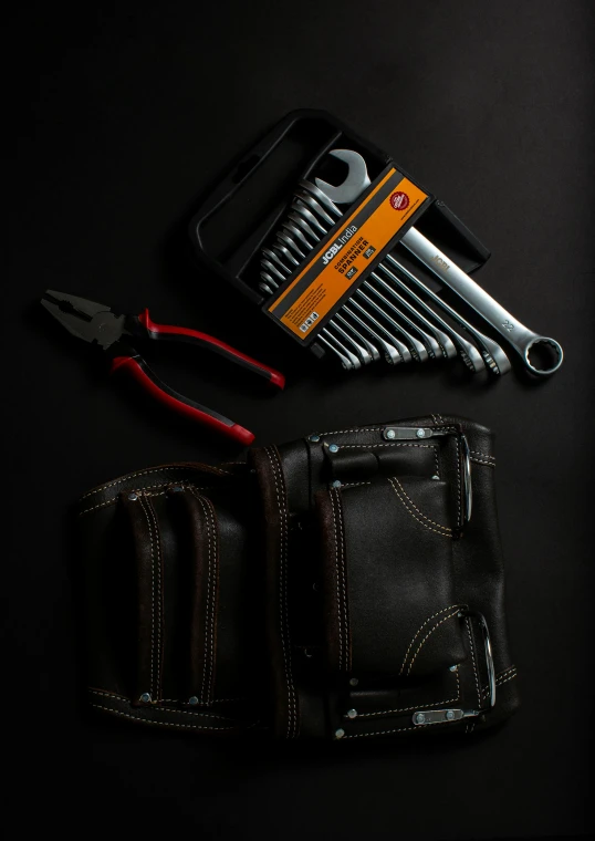 a pair of scissors next to an open tool pouch