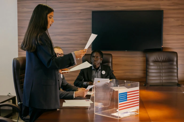 two business women with papers in a conference room