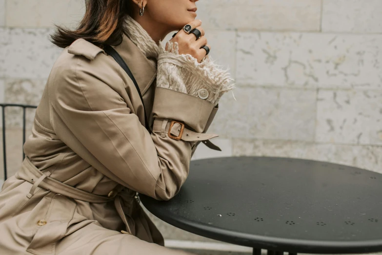 a woman sits down with her umbrella in front of her