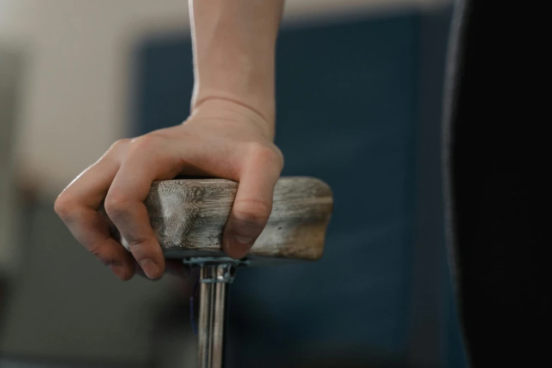 a person with their hand on a piece of wood