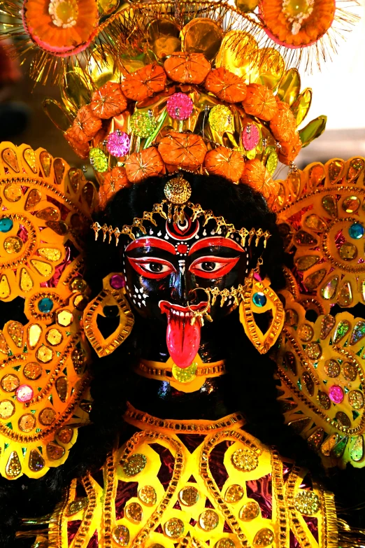 brightly colored mask and elaborate head piece displayed