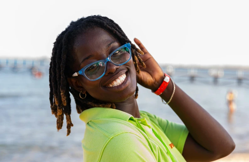 an african american woman in glasses poses for a picture