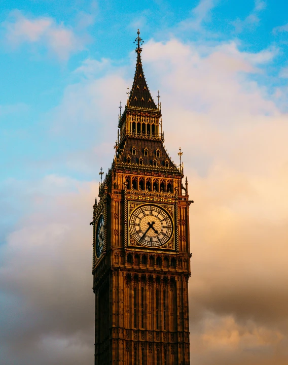 a tower with an clock is against a dark blue sky