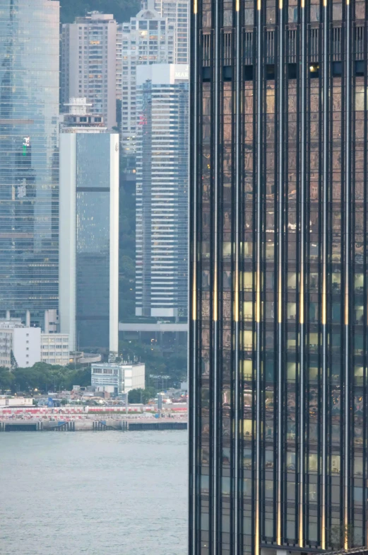 a tall building in a city by the water