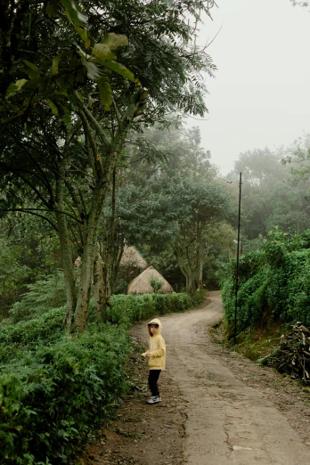 a child is walking down a dirt road