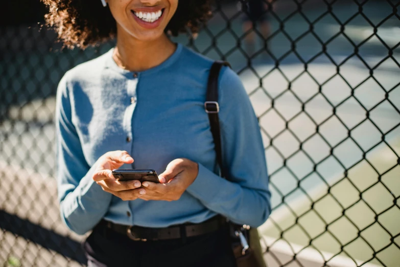 a close up of a person holding a cell phone