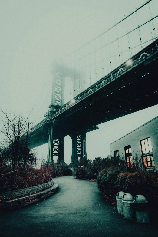 a large bridge is in the sky over an area that looks like it could be a small town