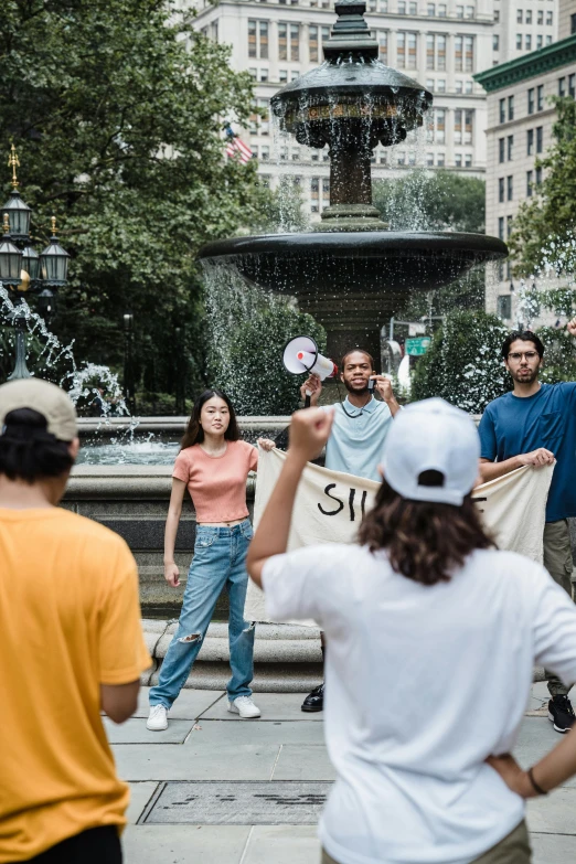 people in front of a fountain with a sign that reads 911