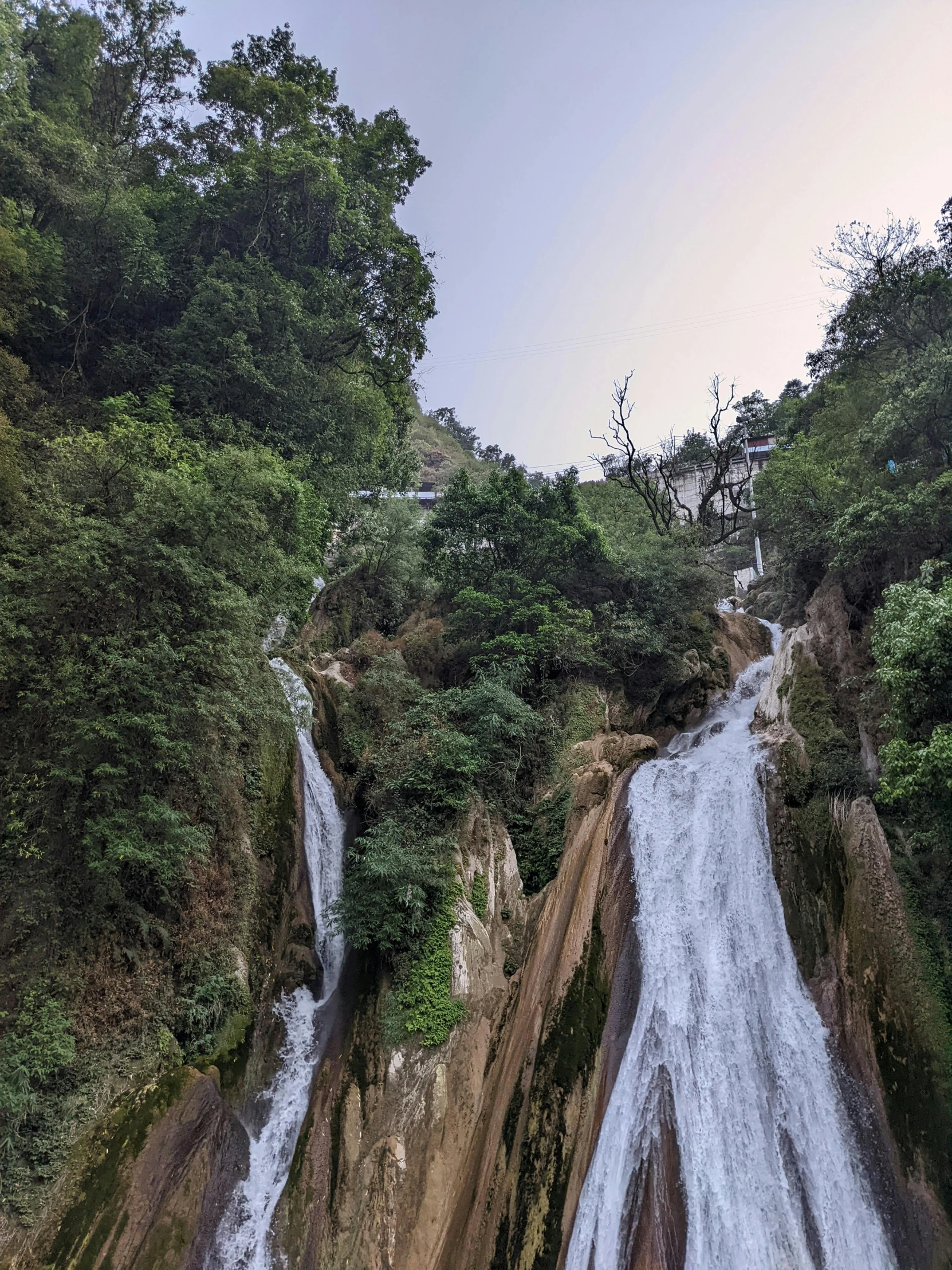 a couple of people on top of some small waterfalls