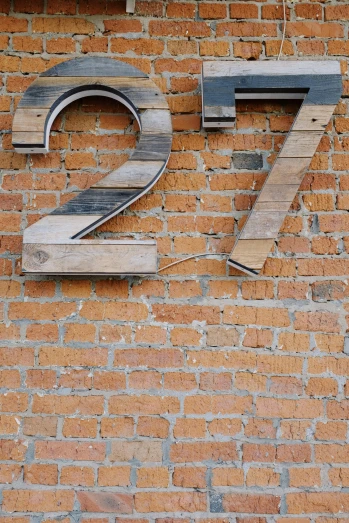the number twenty seven written on a brick wall