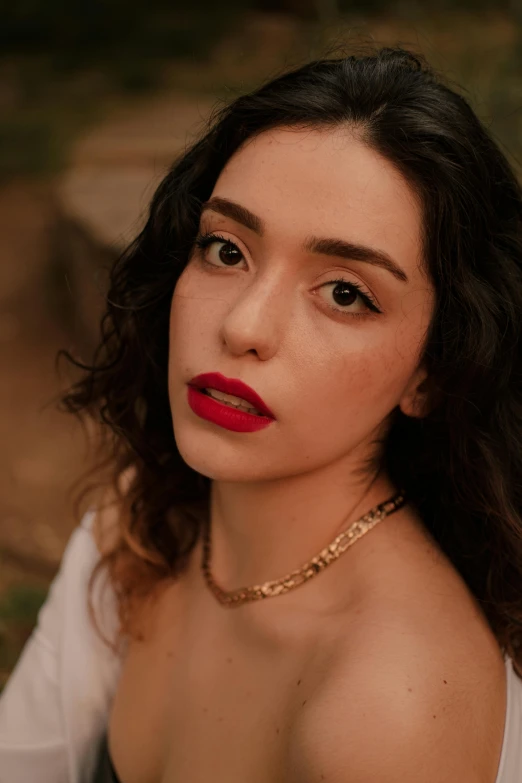 an attractive young woman wearing red lipstick on her face