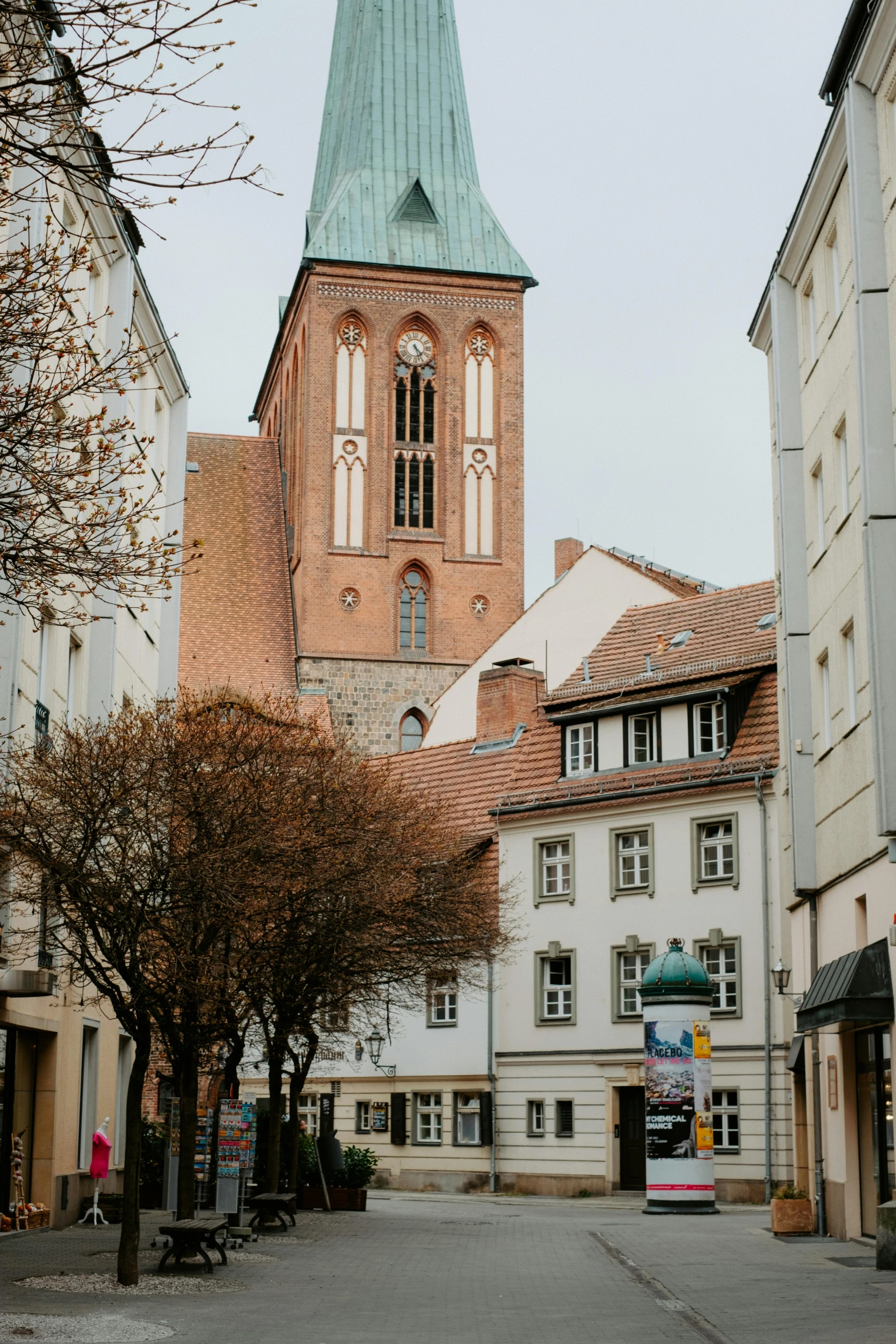 a street has buildings and a building with a steeple