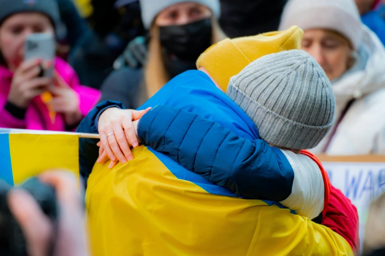 some people in a crowd with one person hugging