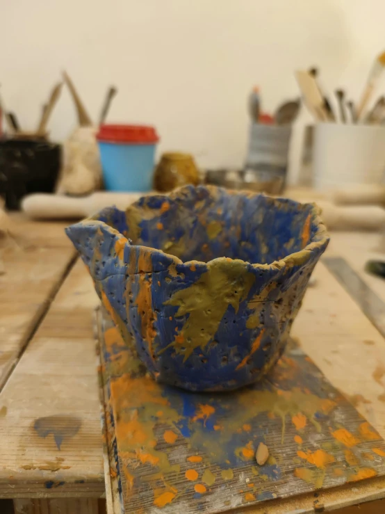 a painted bowl on top of an old table