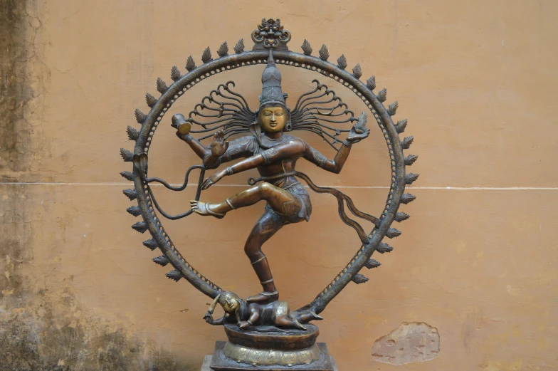 a statue of a woman in a circle with wings