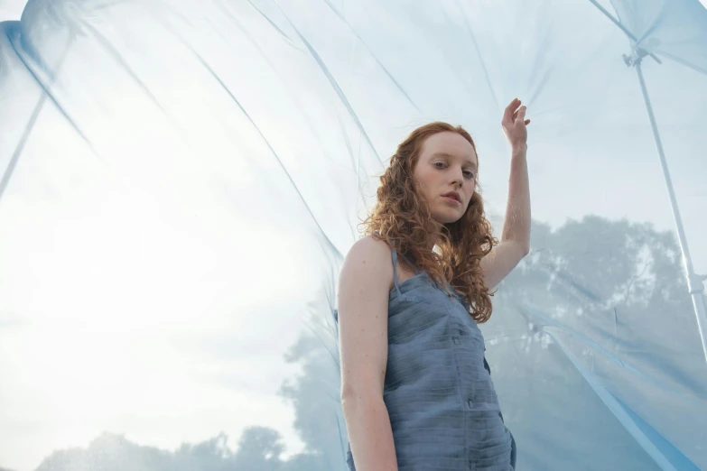 a woman is holding up an umbrella in the air