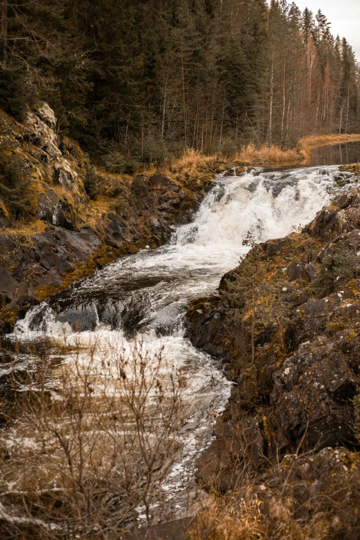 there is a waterfall flowing down a hill side