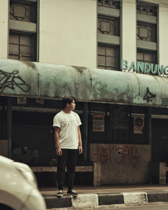 a man standing in front of a closed up building