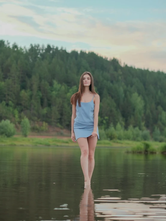 a woman standing on a body of water