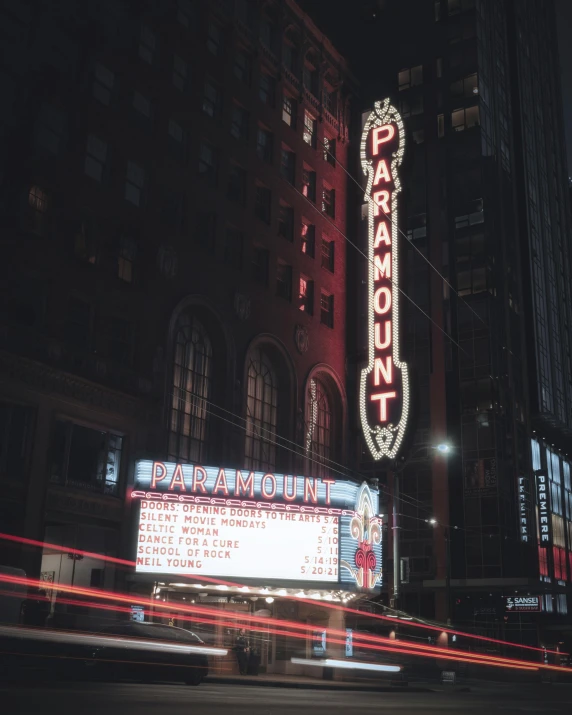 a car moving past the marquee in the city