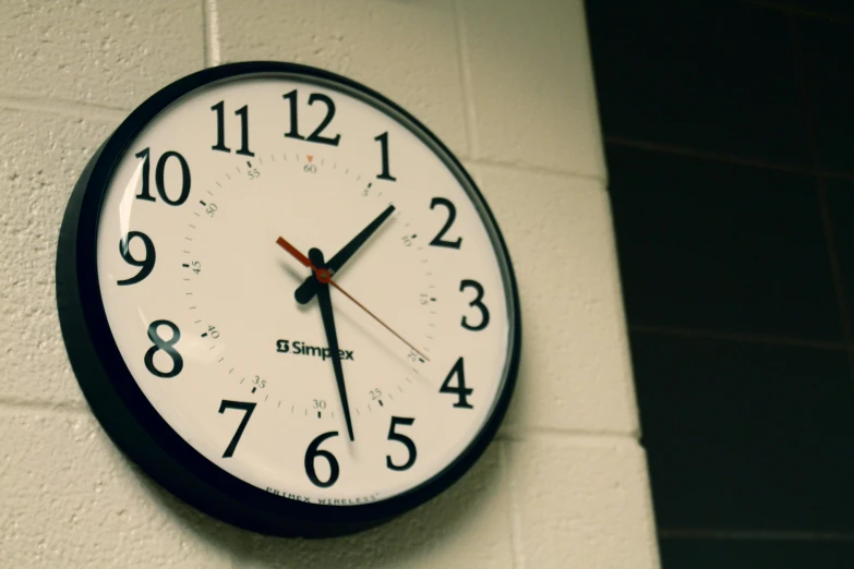 a clock showing six o'clock on a wall