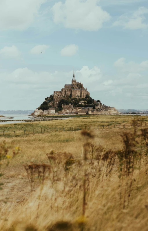 an ancient castle stands on top of a large island