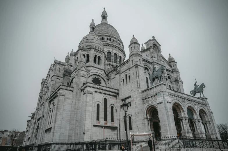 an old gothic style church is shown in the snow