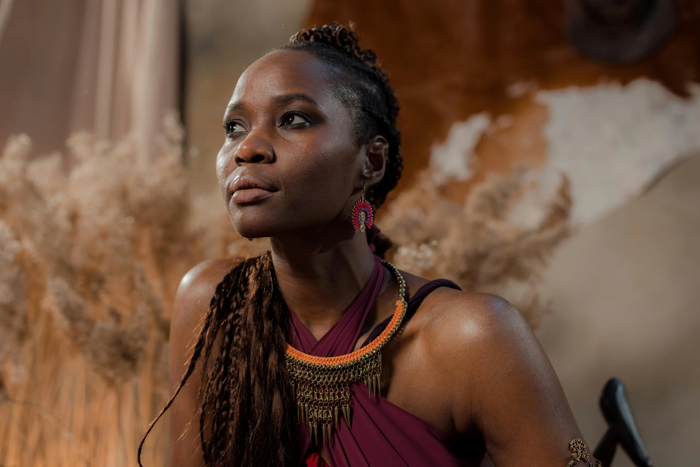 an attractive young woman wearing large necklaces and hair on her head