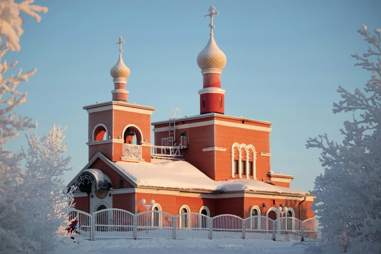 a church surrounded by snow with white trim