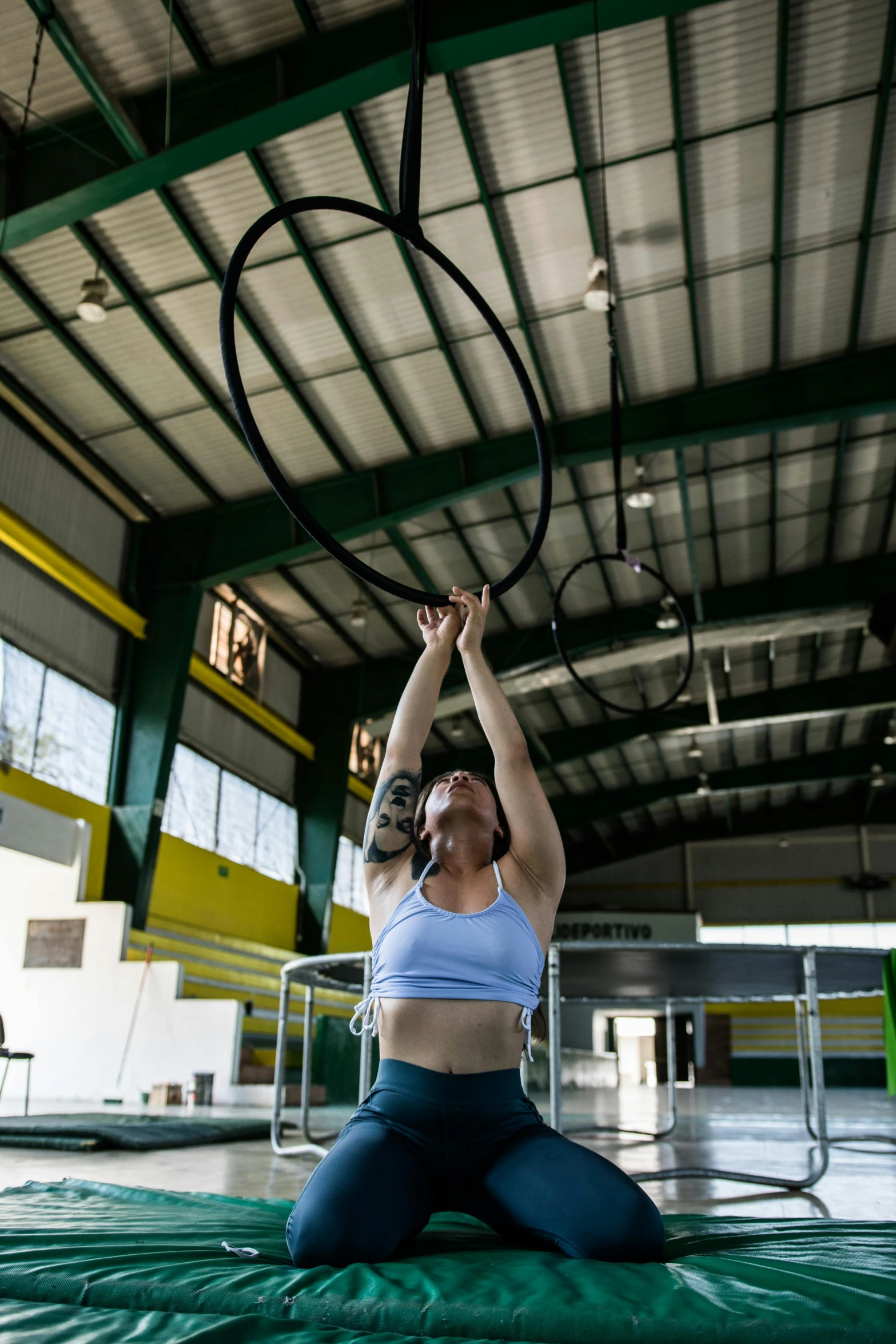 a woman with a hoop is doing exercises on a mat