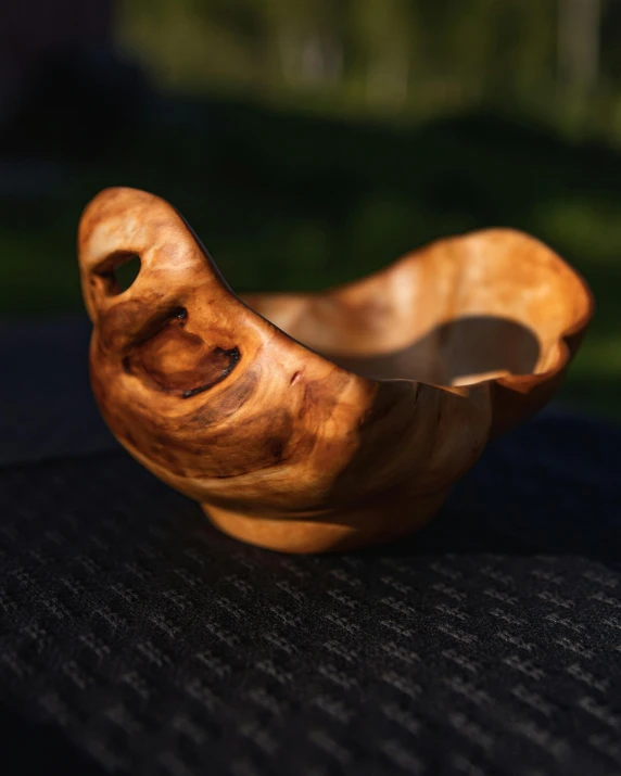 a small wooden sculpture of a bird made of wood
