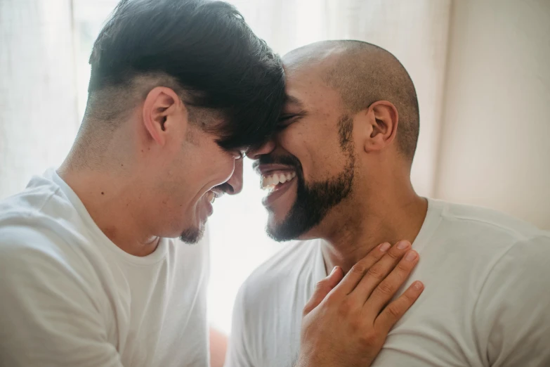 two men laugh together and look to each other