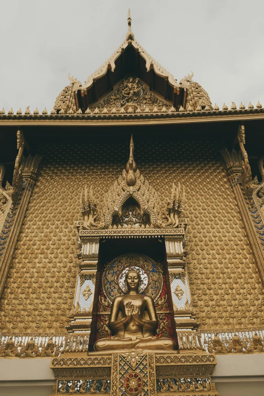 there is a gold buddha statue with a white background