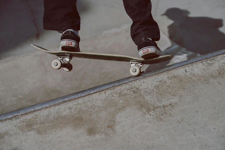 the skateboarder is about to fall down the concrete steps