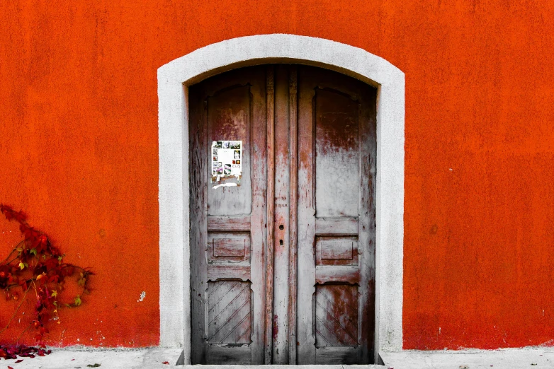 a door and a sidewalk sign on a wall