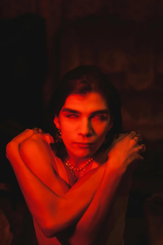 a woman with brown hair and a choker in red light
