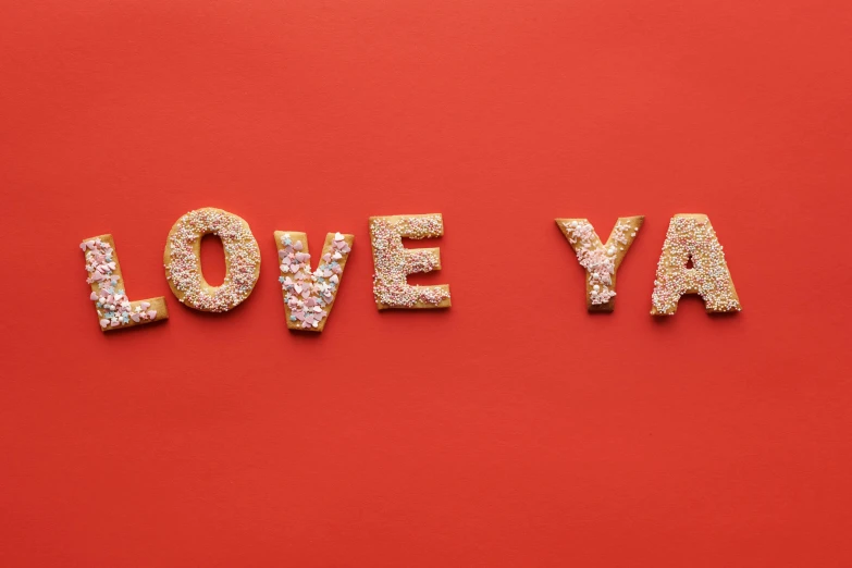 the words love ya spelled in glitter gold letters