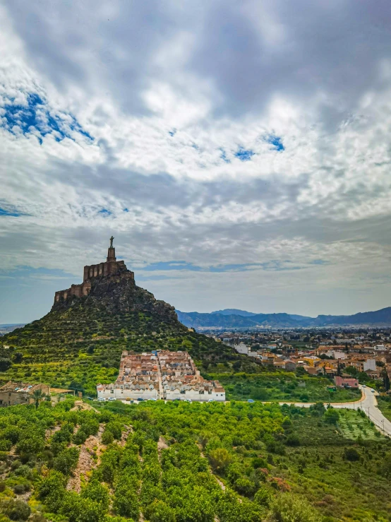 there is a mountain with a tower and a town