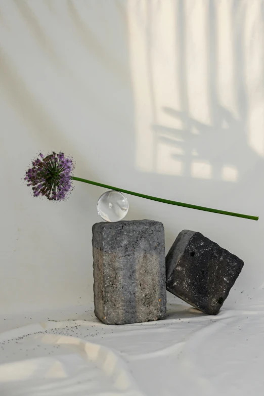 small rock sculpture next to a small piece of concrete