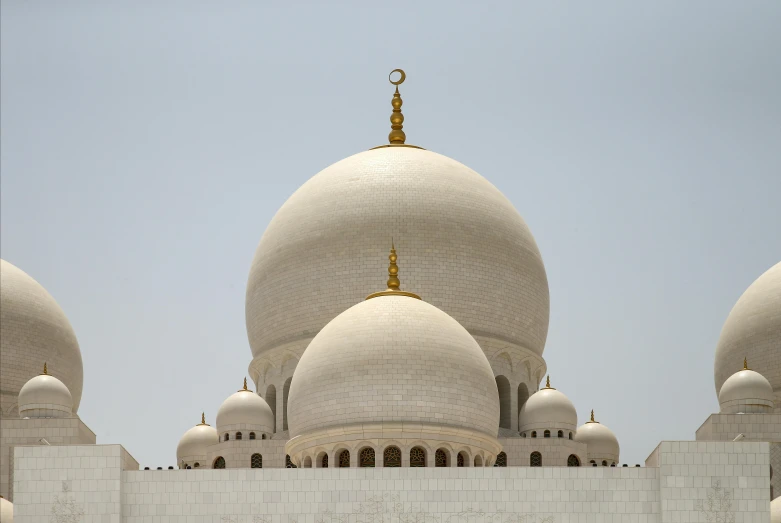 a large white building with several domes on it