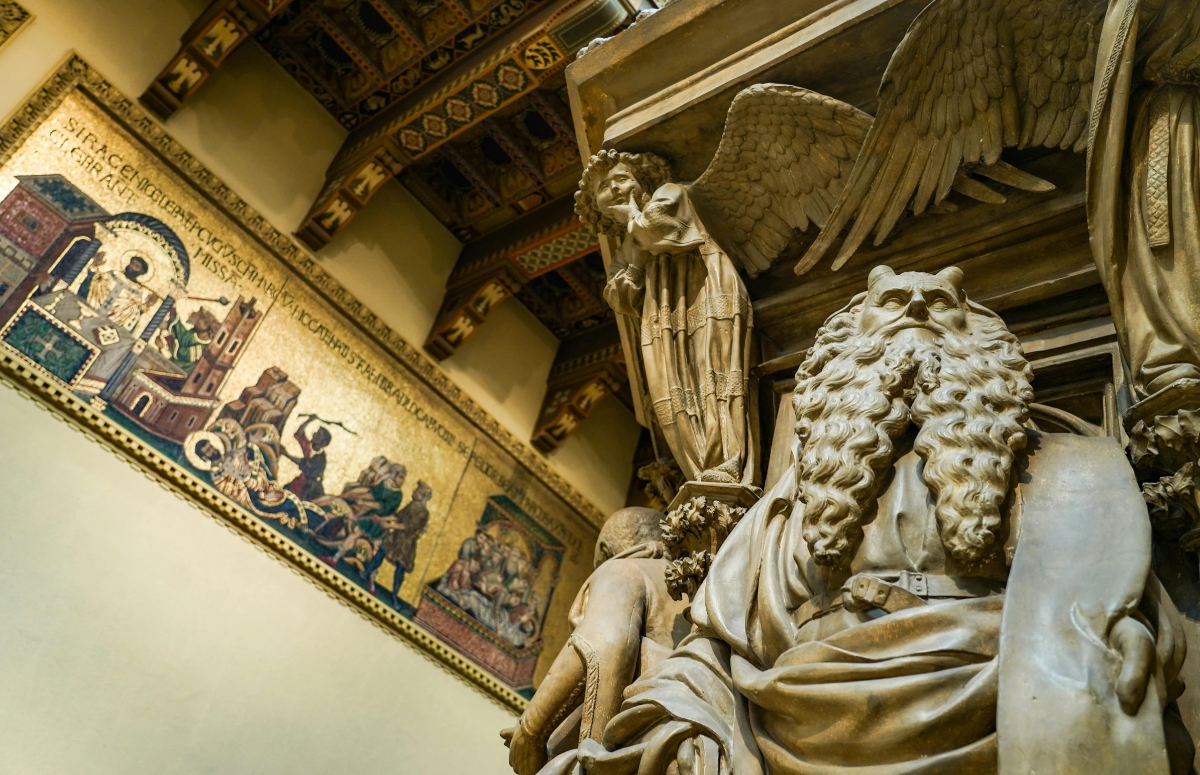 the statue in the room is covered by an intricately decorated wall