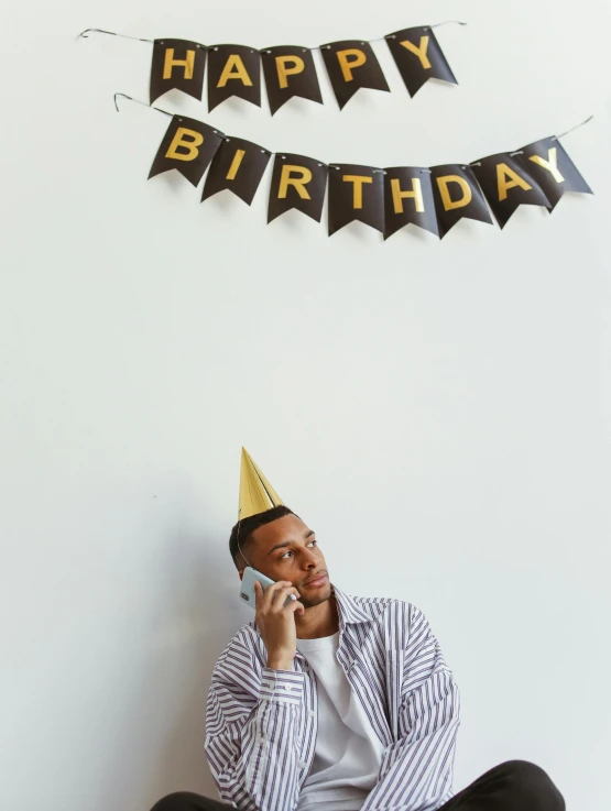 a man sitting with his head down talking on the phone