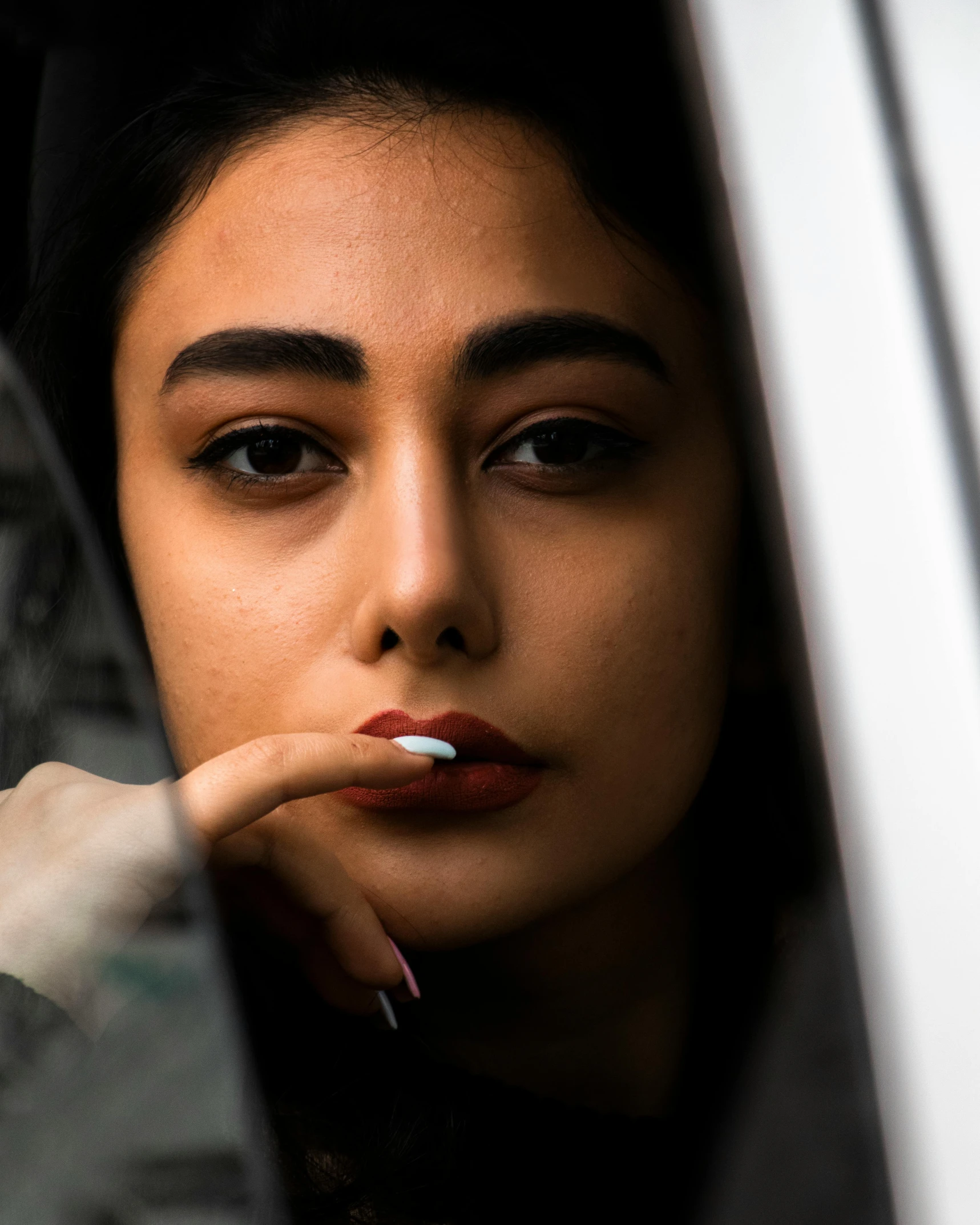 a woman with her cigarette sticking out of a window